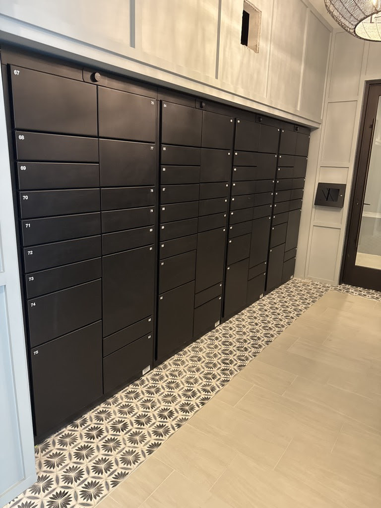 Luxer One® indoor package locker bank with numbered compartments in a Class-A Dallas residential lobby